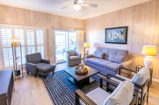 a living room with furniture and wooden floor