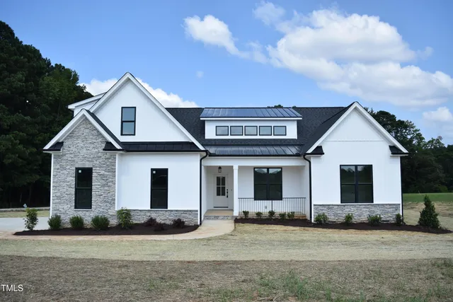a front view of house with yard and green space