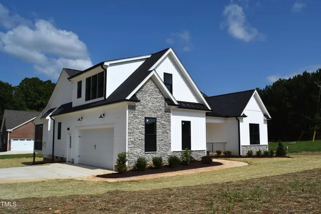 a view of a house with wooden fence
