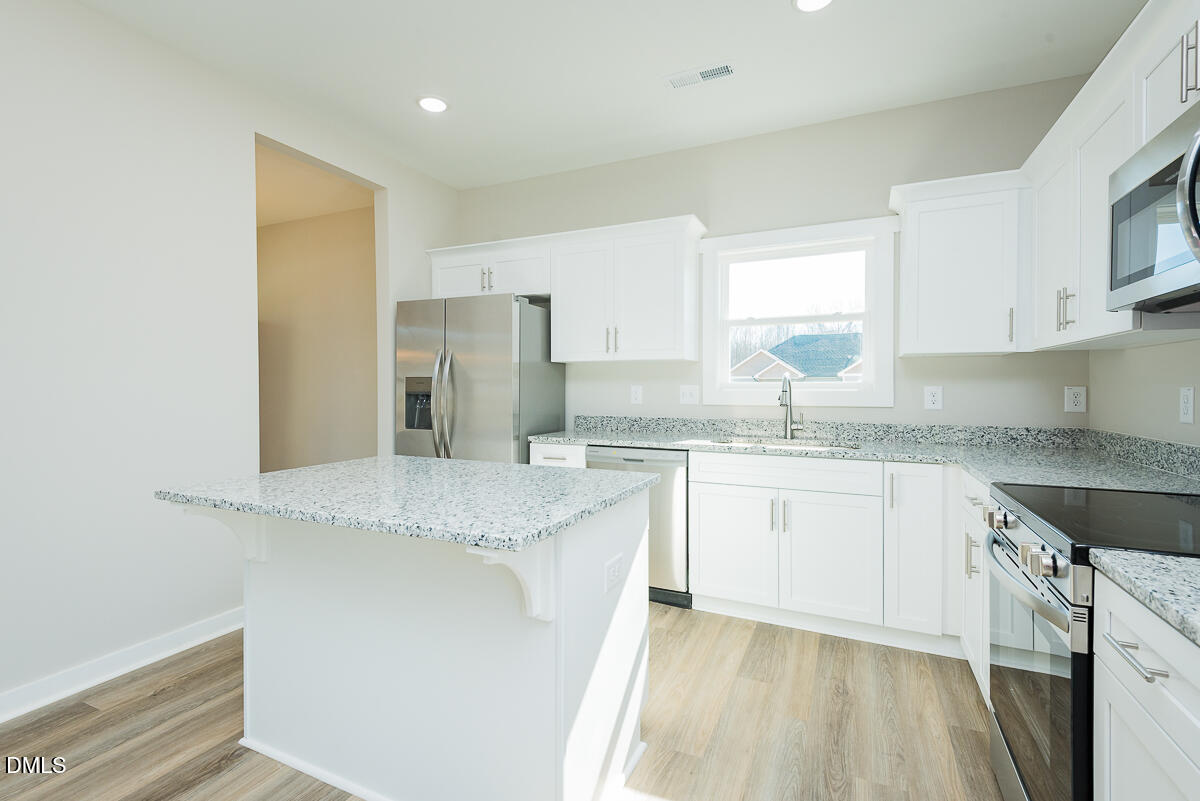 1125 Scarlet Oak Rd Spring Spring Hope, NC 27882 - Photo 11 of 29 a kitchen with granite countertop cabinets stainless steel appliances a sink and a window