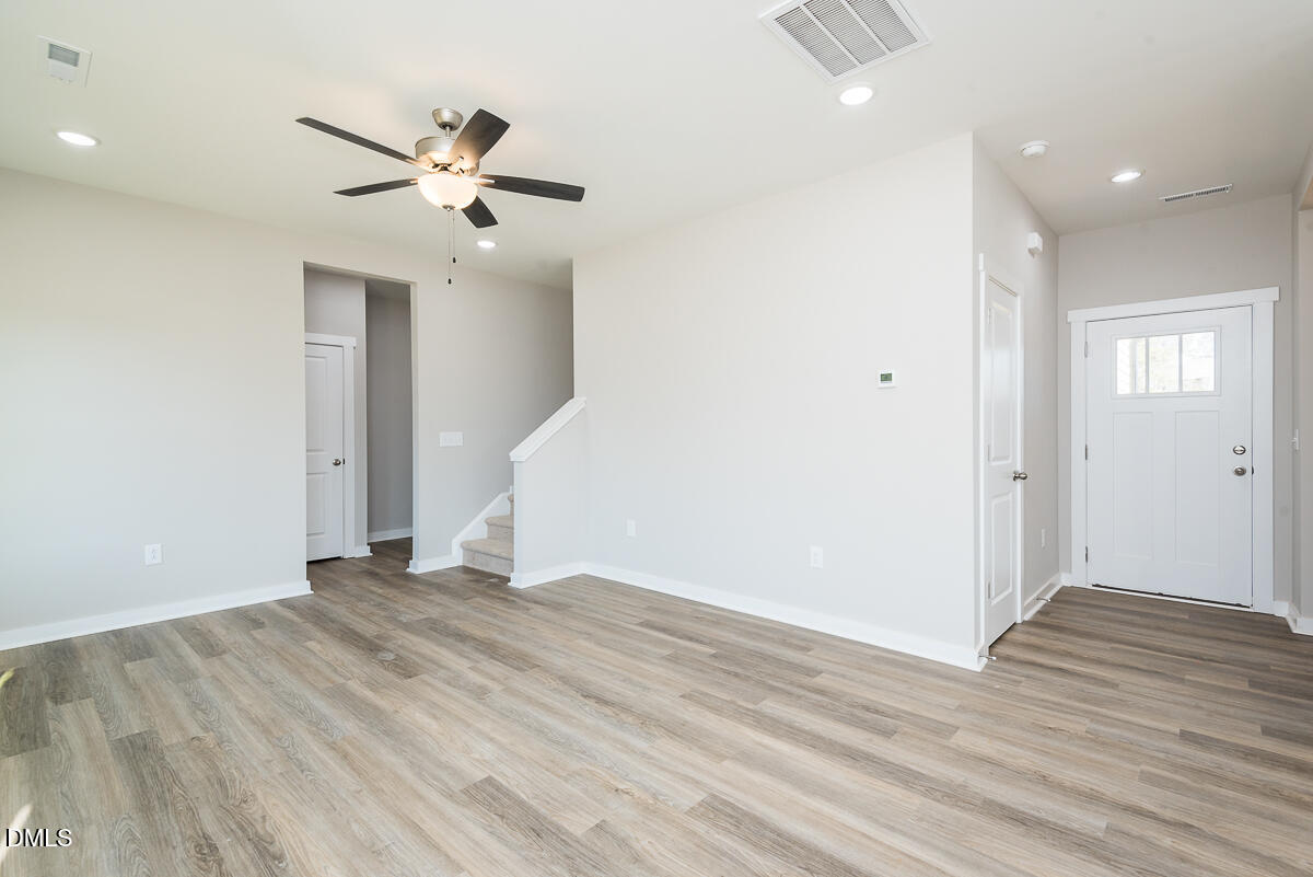 1125 Scarlet Oak Rd Spring Spring Hope, NC 27882 - Photo 12 of 29 a view of an empty room with wooden floor and a ceiling fan