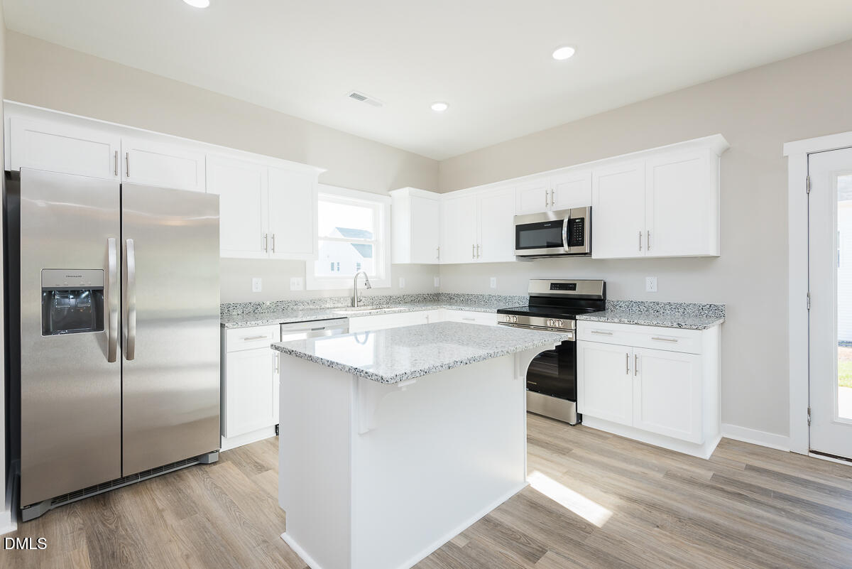 1125 Scarlet Oak Rd Spring Spring Hope, NC 27882 - Photo 5 of 29 a kitchen with a refrigerator stove and microwave