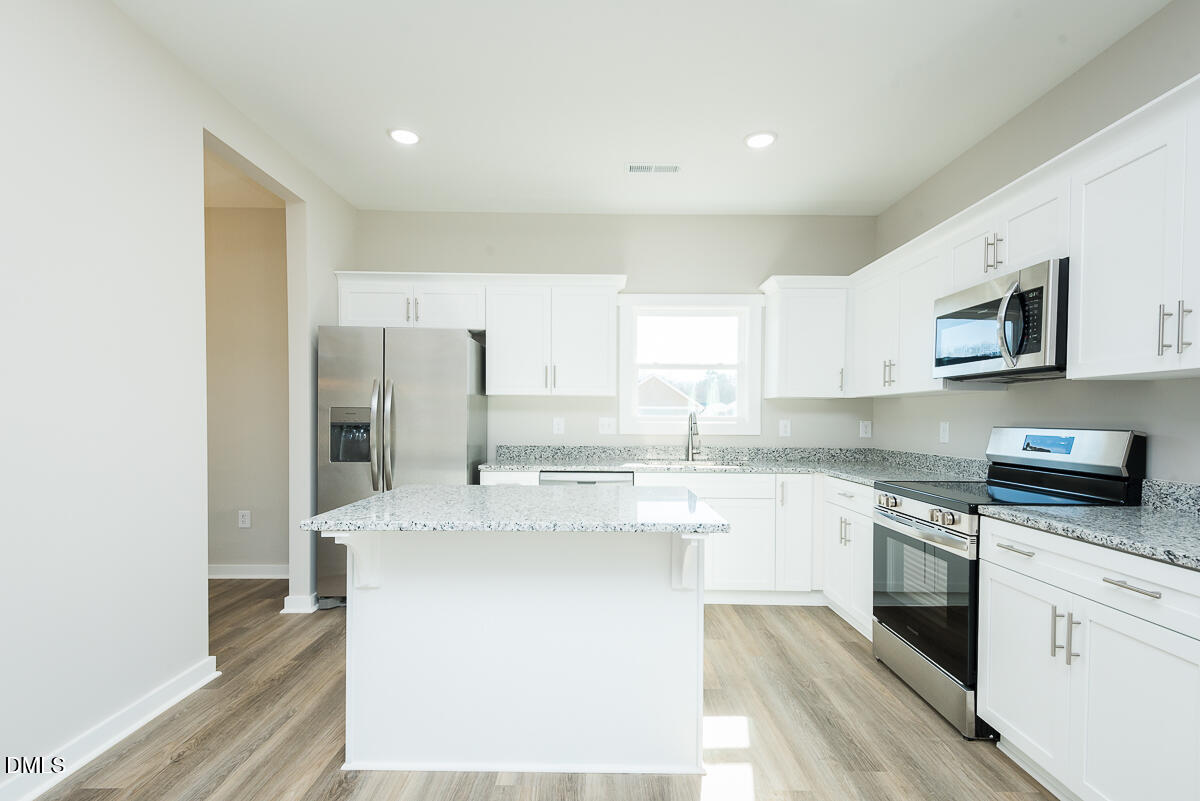 1125 Scarlet Oak Rd Spring Spring Hope, NC 27882 - Photo 6 of 29 a large kitchen with stainless steel appliances granite countertop a stove a sink and a refrigerator