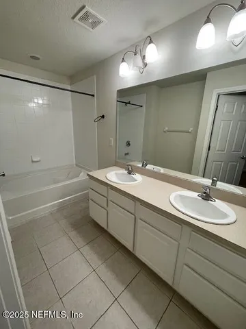 a view of a livingroom with a ceiling fan and window