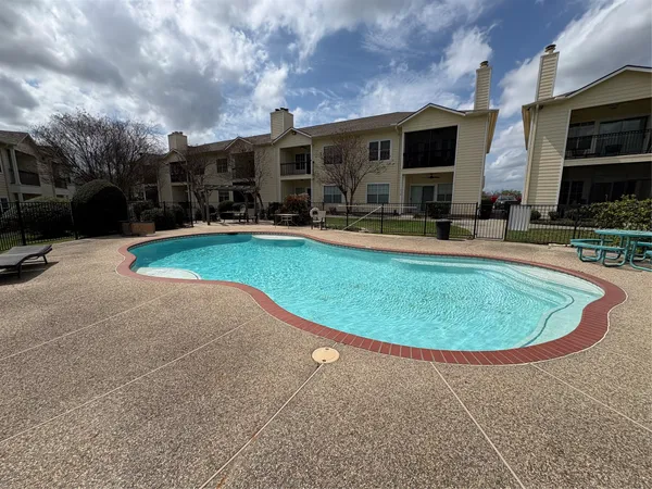 a view of a swimming pool with outdoor seating