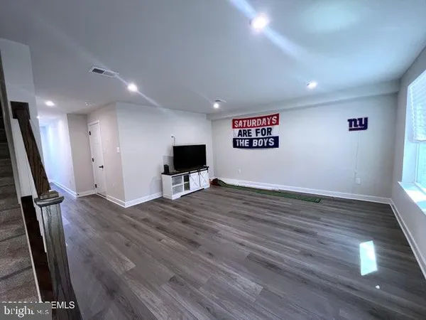 a view of a dining room with furniture a rug and wooden floor
