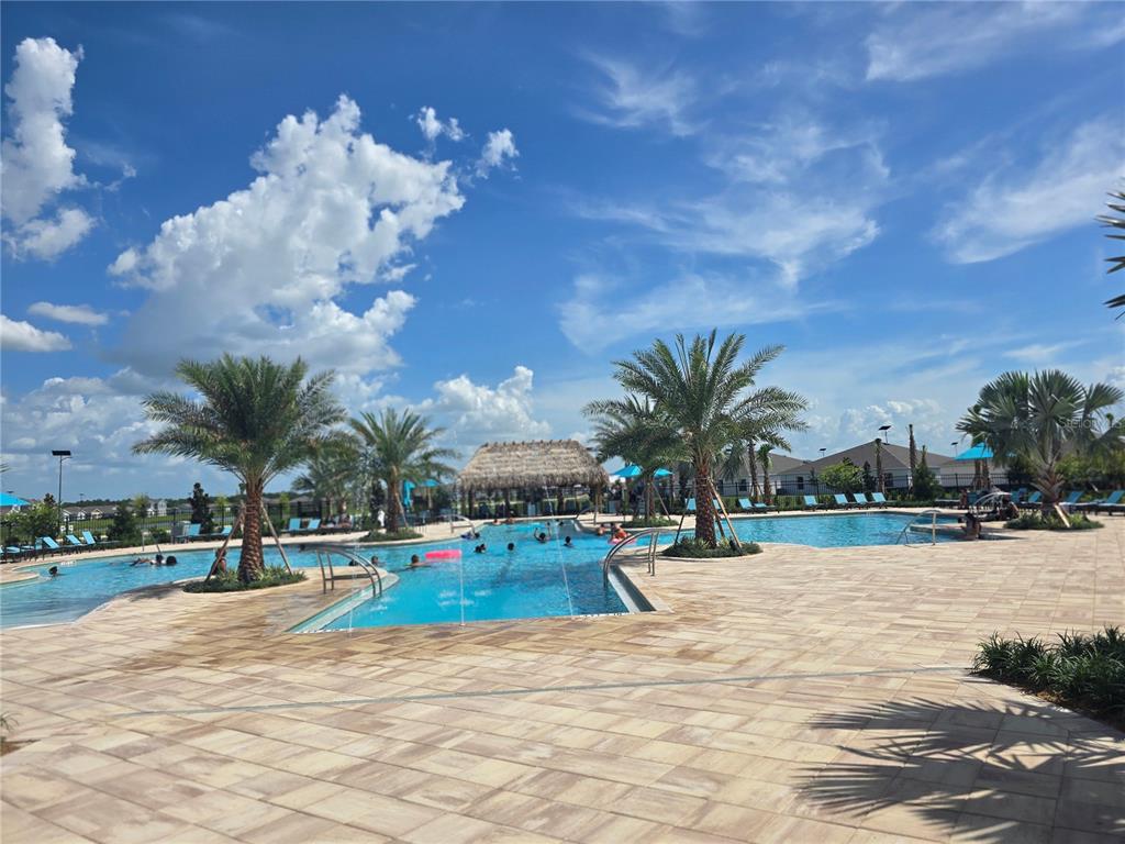 1767 Foreman Road Eagle Lake, FL 33839 - Photo 21 of 30 a view of swimming pool with seating area and trees in the background
