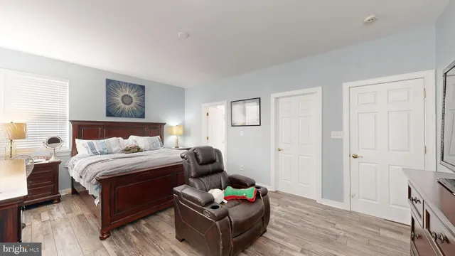 a bedroom with bed couch and window