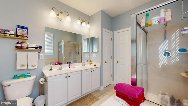 a bathroom with a sink mirror vanity and toilet