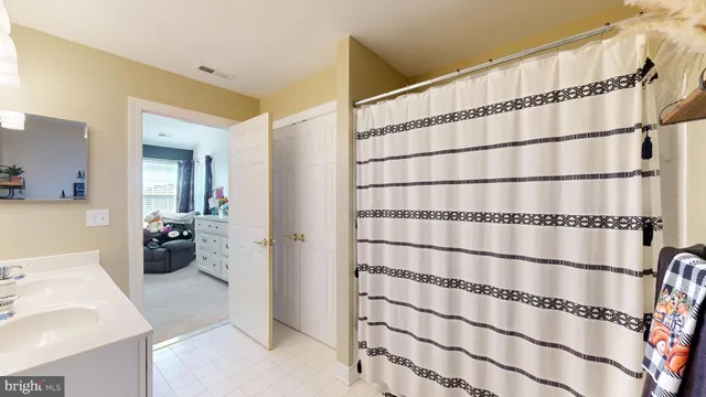 a bathroom with a window and a shower