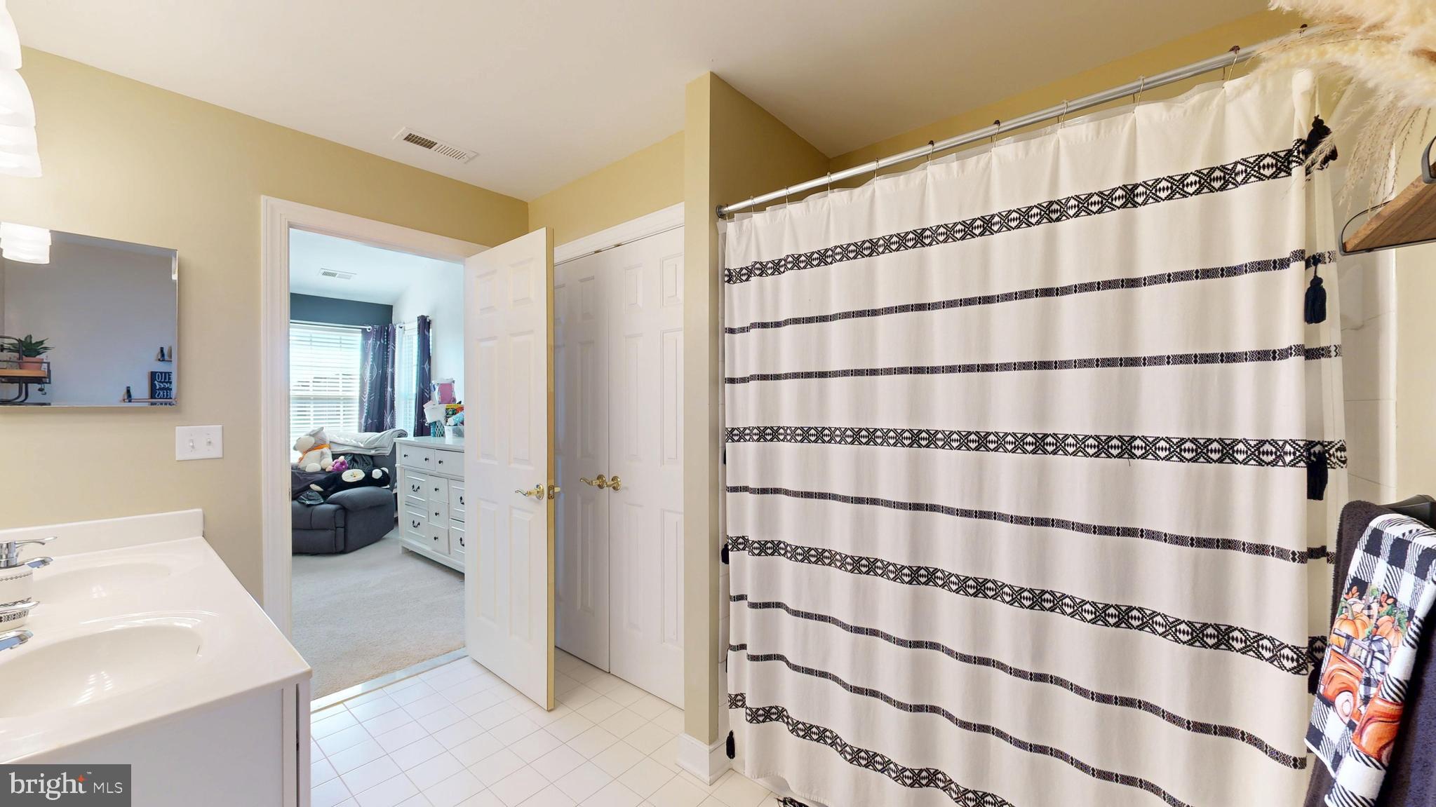 24875 Rivers Edge Road Millsboro, DE 19966 - Photo 24 of 48 a bathroom with a window and a shower