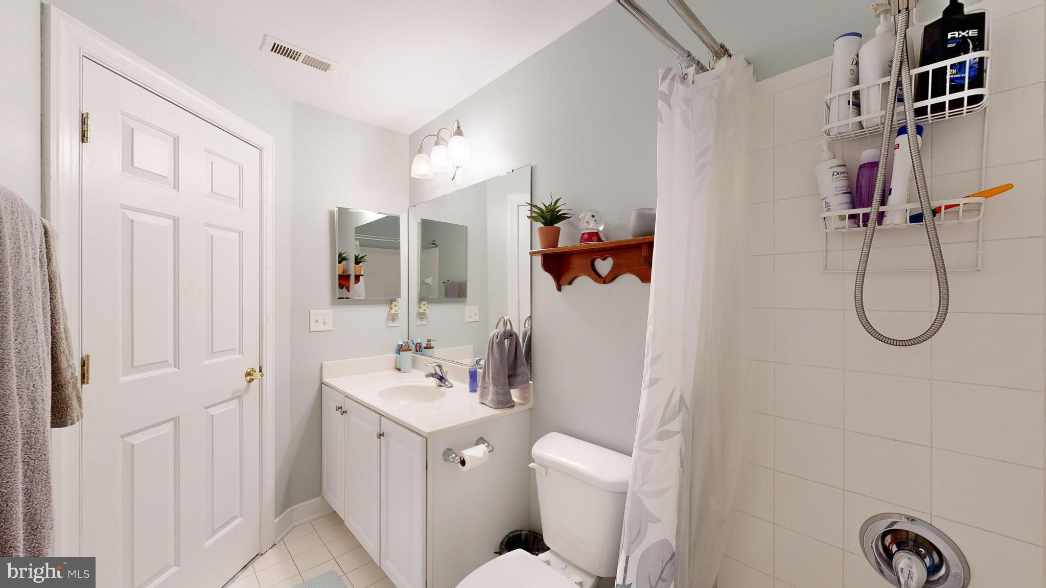 24875 Rivers Edge Road Millsboro, DE 19966 - Photo 28 of 48 a bathroom with a sink vanity mirror and toilet