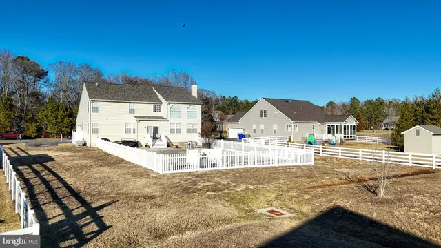a view of house with yard and sitting area