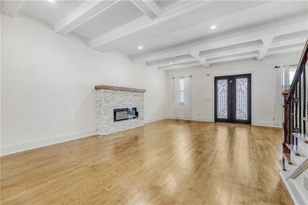 a large kitchen with granite countertop a large counter top a sink stainless steel appliances and cabinets