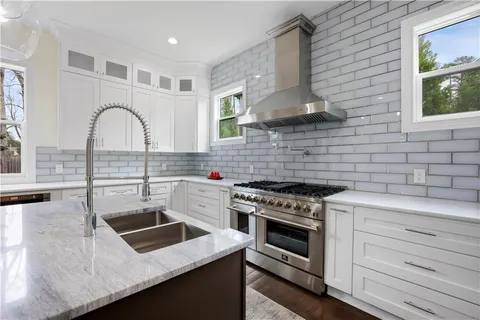 a kitchen with stainless steel appliances cabinets and a stove