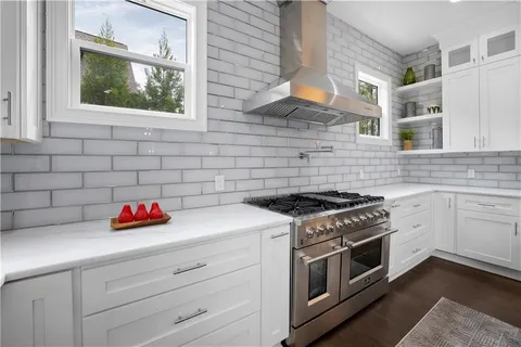 a kitchen with a sink stove and cabinets