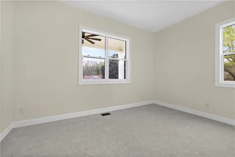 a bathroom with a granite countertop sink a toilet and shower