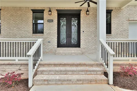 a view of staircase with railing and a potted plant