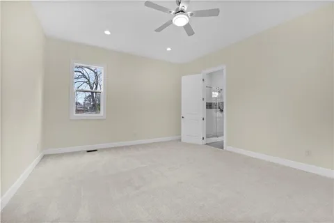 a view of a hallway with wooden floor and windows
