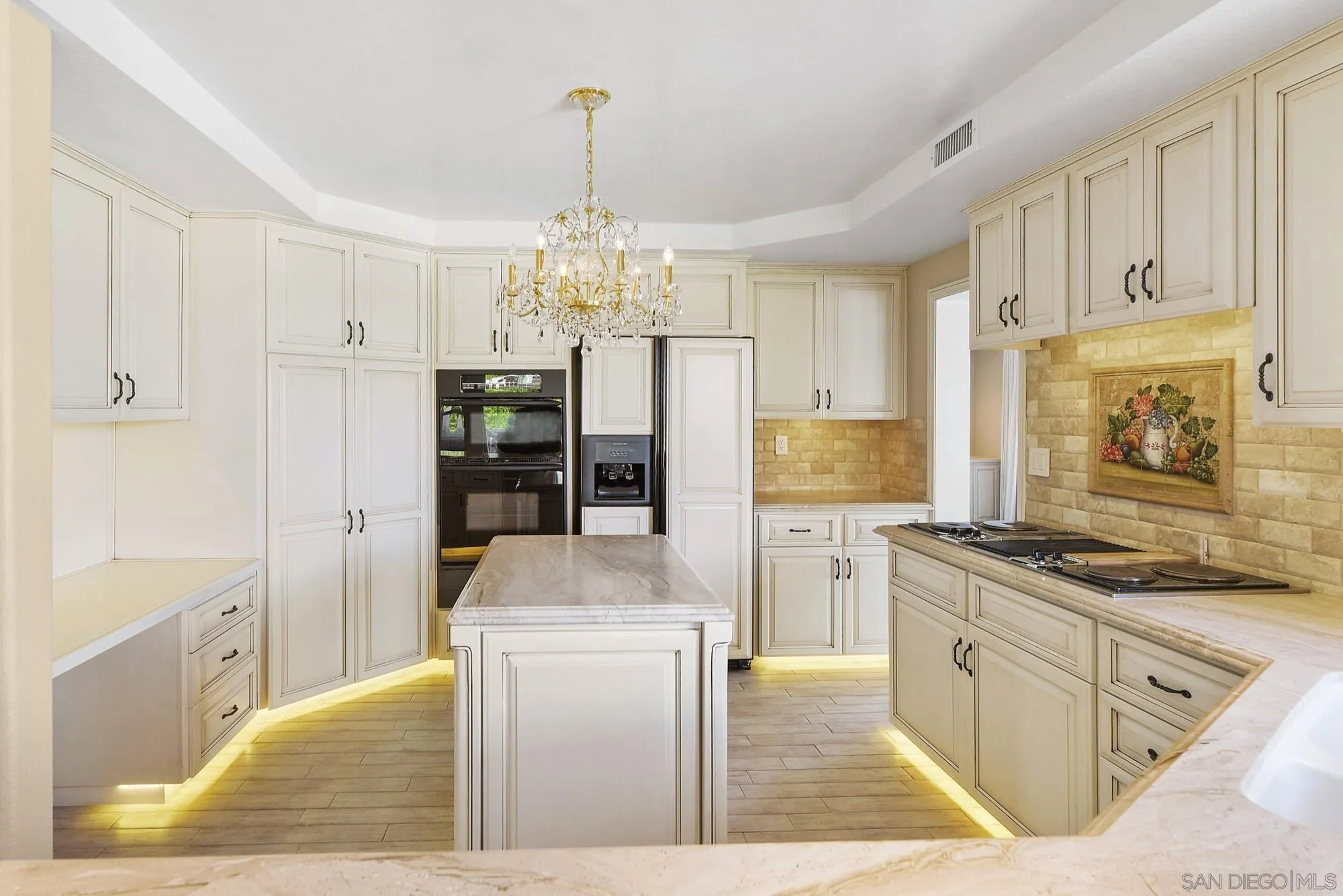 13000 Lomas Verdes Drive Poway, CA 92064 - Photo 12 of 58 a kitchen with stainless steel appliances granite countertop a refrigerator a oven a stove and white cabinets with wooden floor