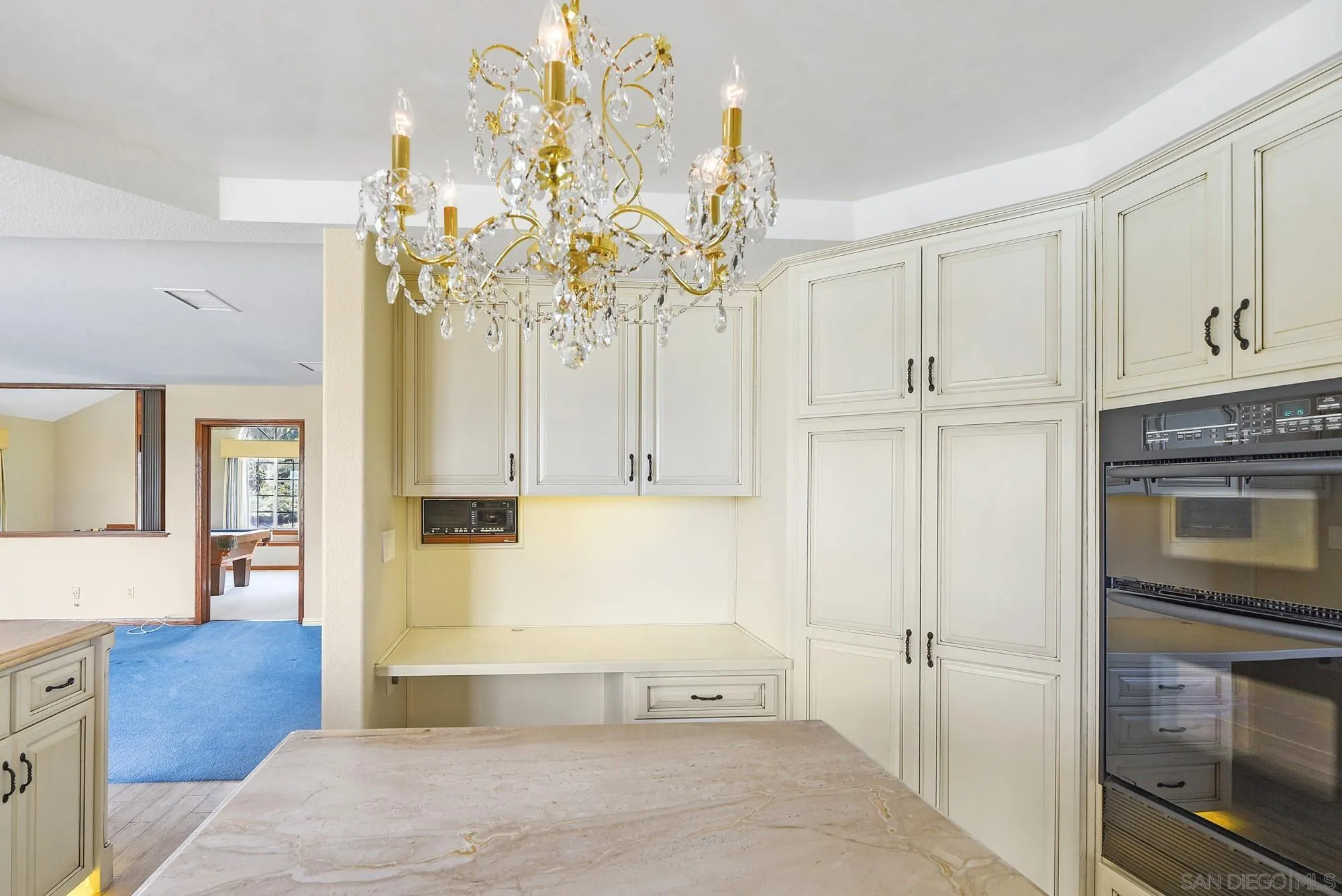 13000 Lomas Verdes Drive Poway, CA 92064 - Photo 14 of 58 a spacious bedroom with a bed and a chandelier