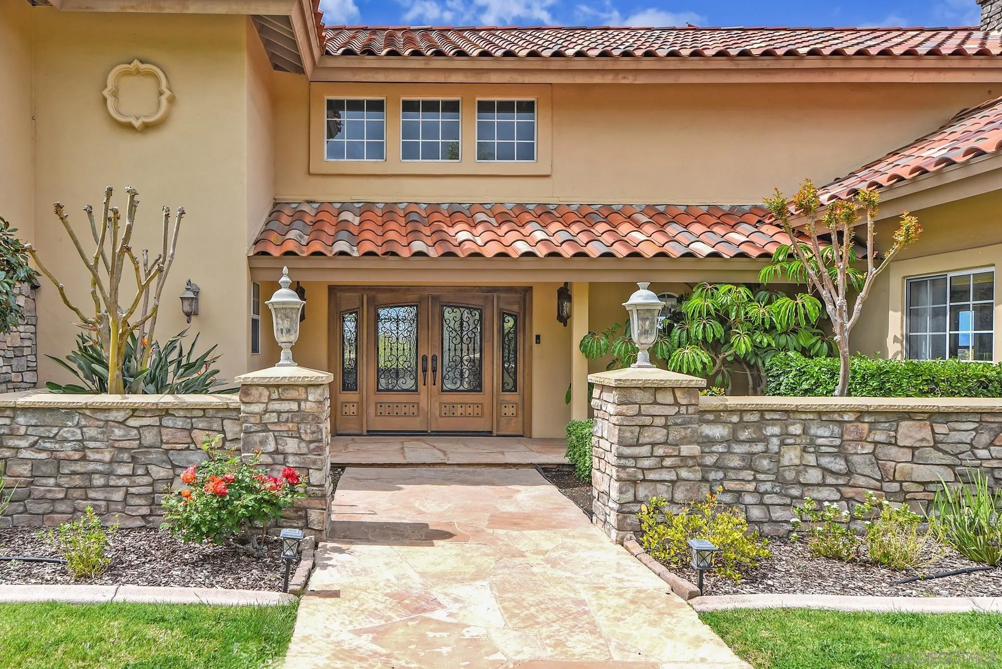 13000 Lomas Verdes Drive Poway, CA 92064 - Photo 3 of 58 a front view of a house with a porch