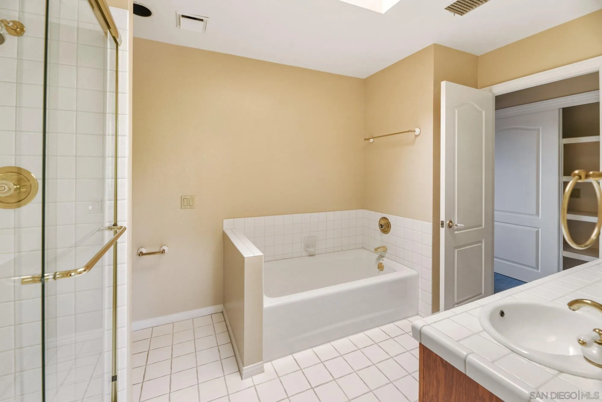 13000 Lomas Verdes Drive Poway, CA 92064 - Photo 45 of 58 a bathroom with a tub and a sink