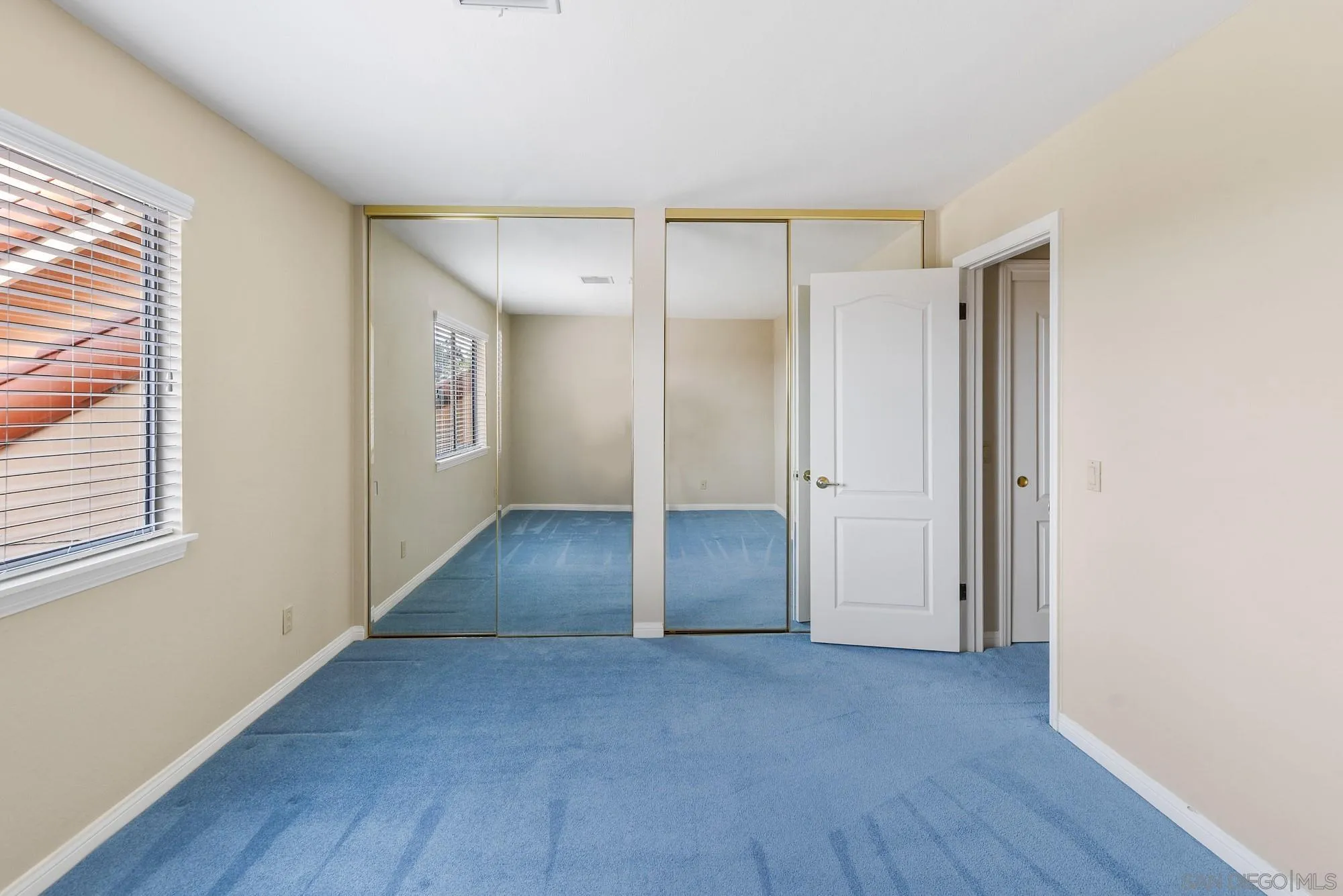 13000 Lomas Verdes Drive Poway, CA 92064 - Photo 47 of 58 an empty room with wooden floor and windows