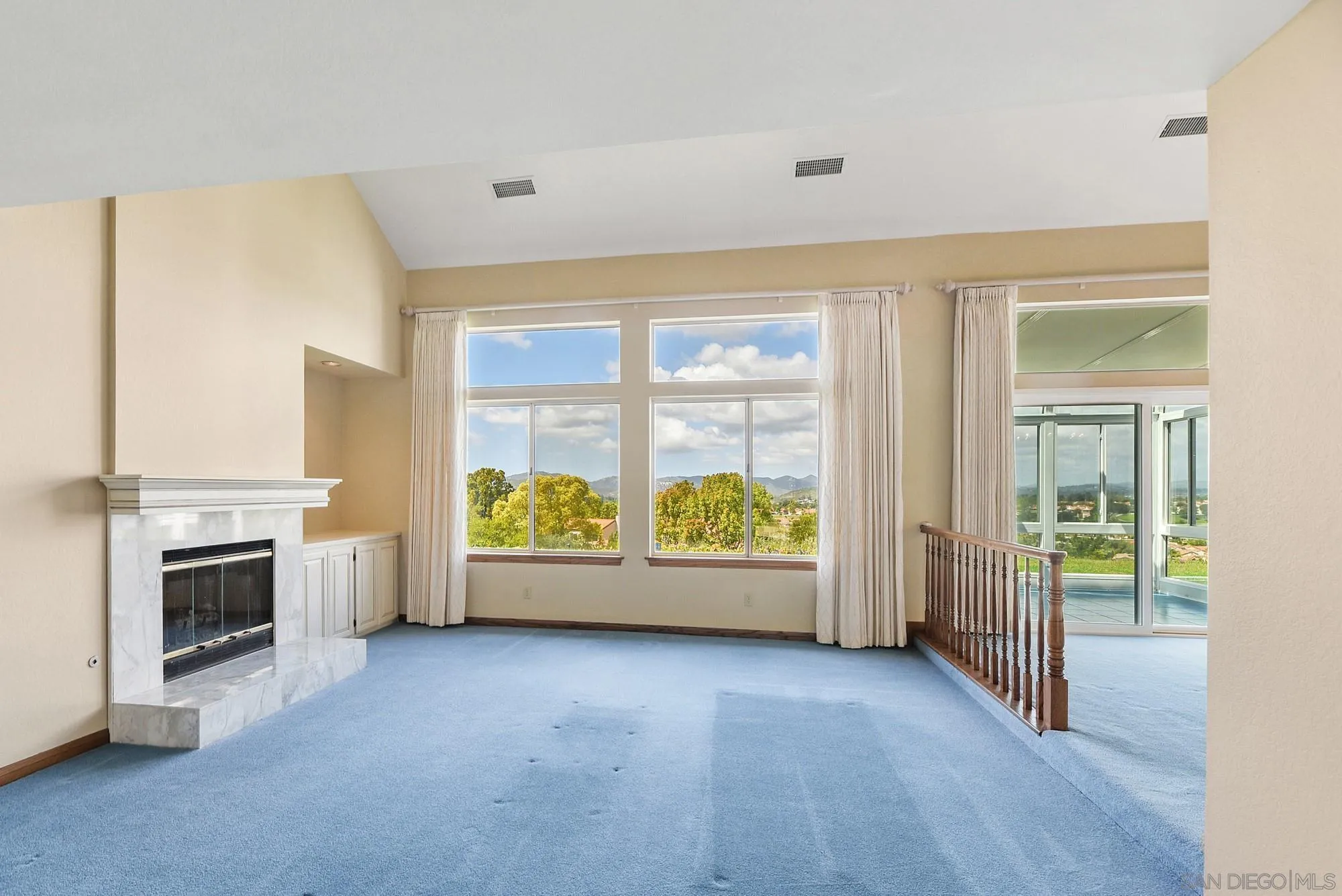 13000 Lomas Verdes Drive Poway, CA 92064 - Photo 7 of 58 a view of an empty room with a window and kitchen view