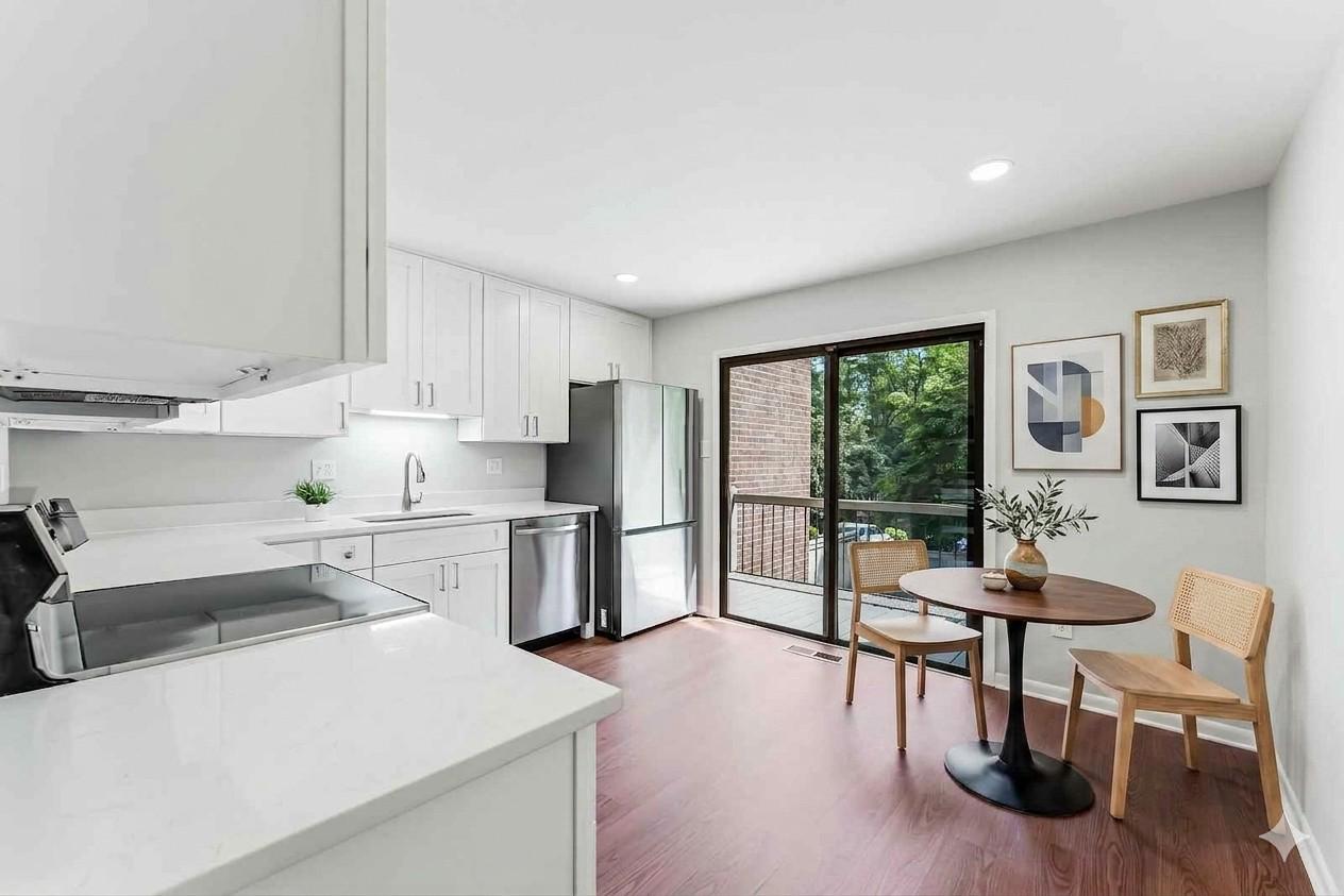 12023 Insha Court Reston, VA 20191 - Photo 17 of 52 a living room with stainless steel appliances kitchen island granite countertop furniture and a wooden floor