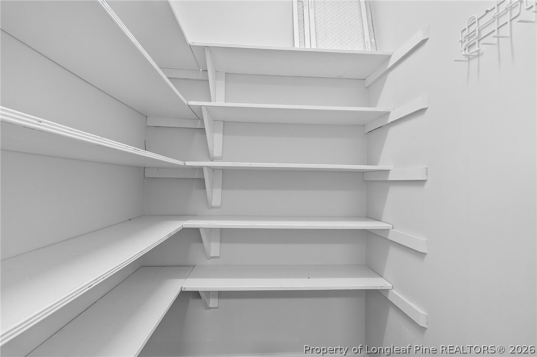 7756 Dragonhead Road Fayetteville, NC 28311 - Photo 23 of 42 a view of walk in closet with empty racks