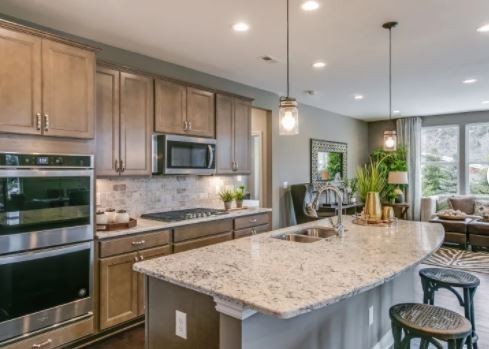 3509 Peace Road Columbia, TN 38401 - Photo 5 of 11 a kitchen with kitchen island granite countertop wooden cabinets and a refrigerator