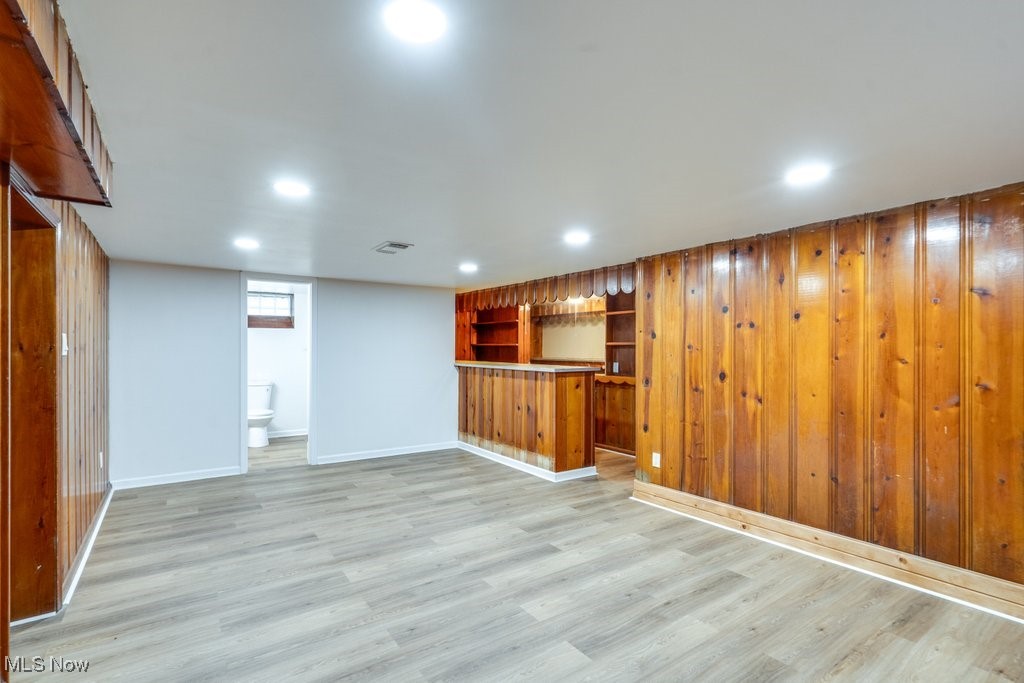 4237 Verona Road Cleveland, OH 44121 - Photo 32 of 41 Below grade area with wooden walls, light wood finished floors, recessed lighting, and bar area