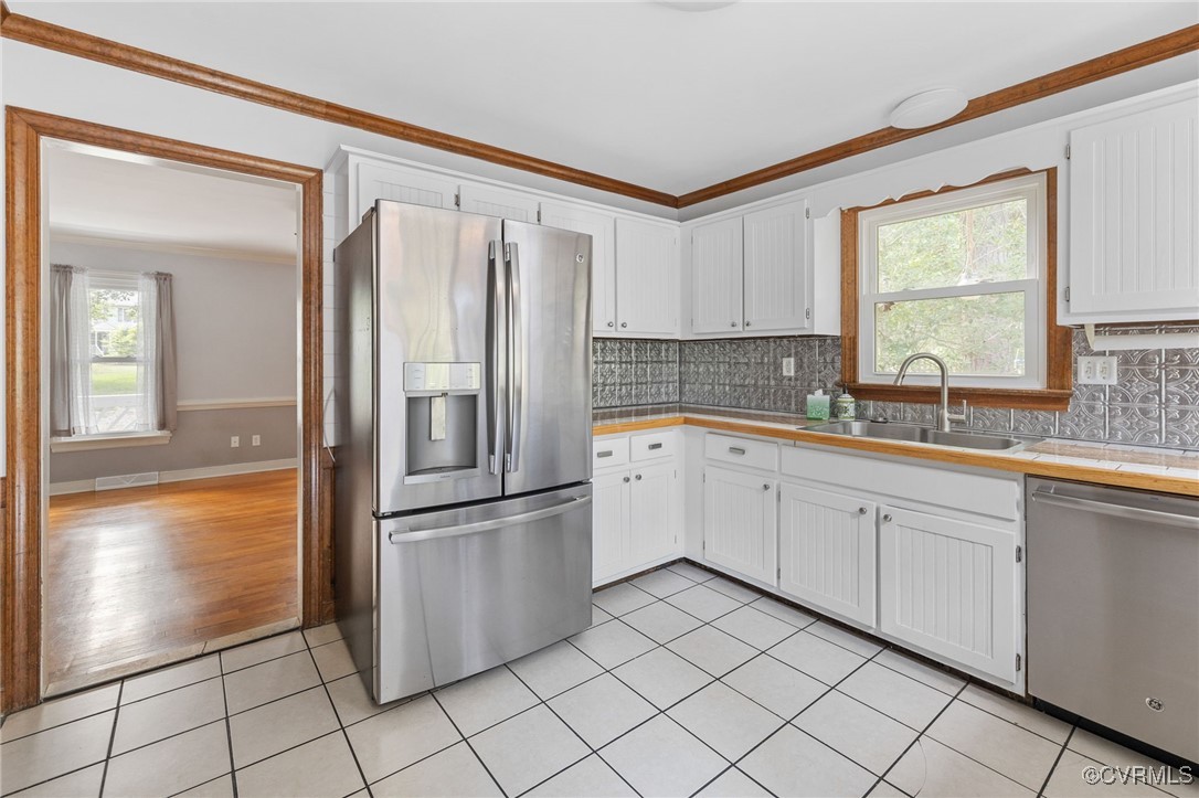 3202 Fortunes Ridge Road Midlothian, VA 23112 - Photo 11 of 29 a kitchen with a refrigerator sink and cabinets