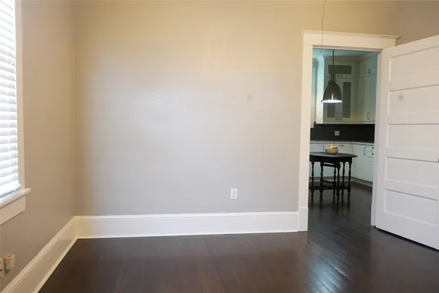 a view of a room with wooden floor and a window