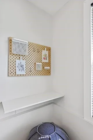 a bathroom with a toilet and a picture