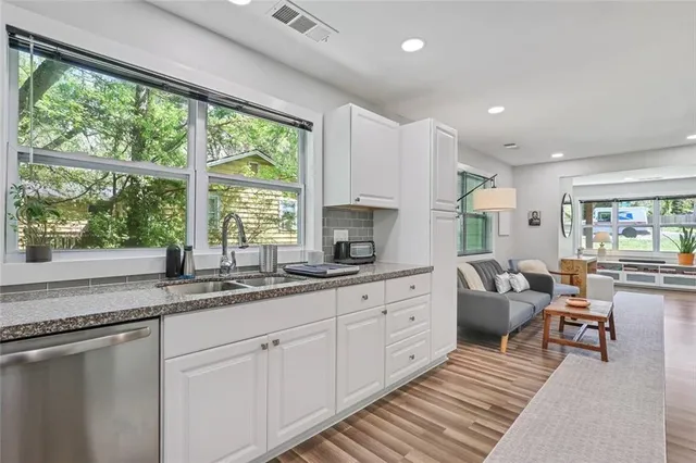 a kitchen with sink attached living room