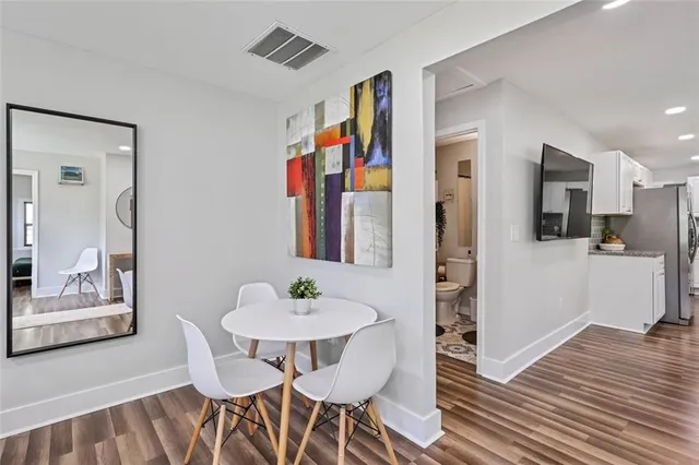 a view of a dining room with furniture and wooden floor