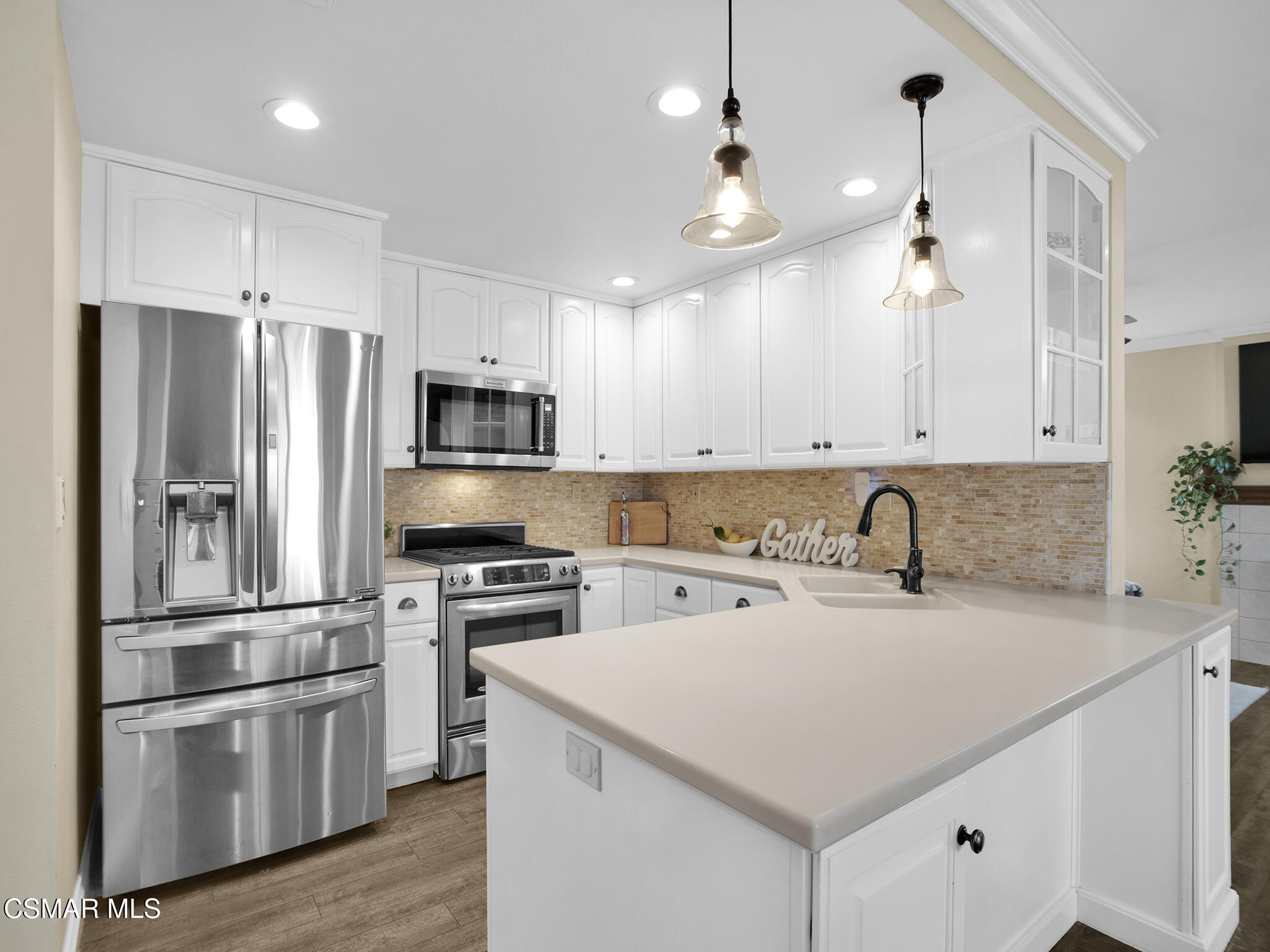 a kitchen with a sink stainless steel appliances and cabinets