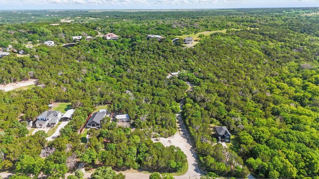 4900 Shining Star Trail Rio Vista, TX 76093 - Photo 2 of 11 a view of a big yard with plants and large trees