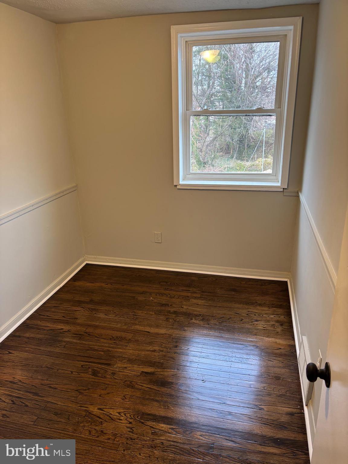 1948 Carter Road Folcroft, PA 19032 - Photo 8 of 8 a view of an empty room with wooden floor and a window