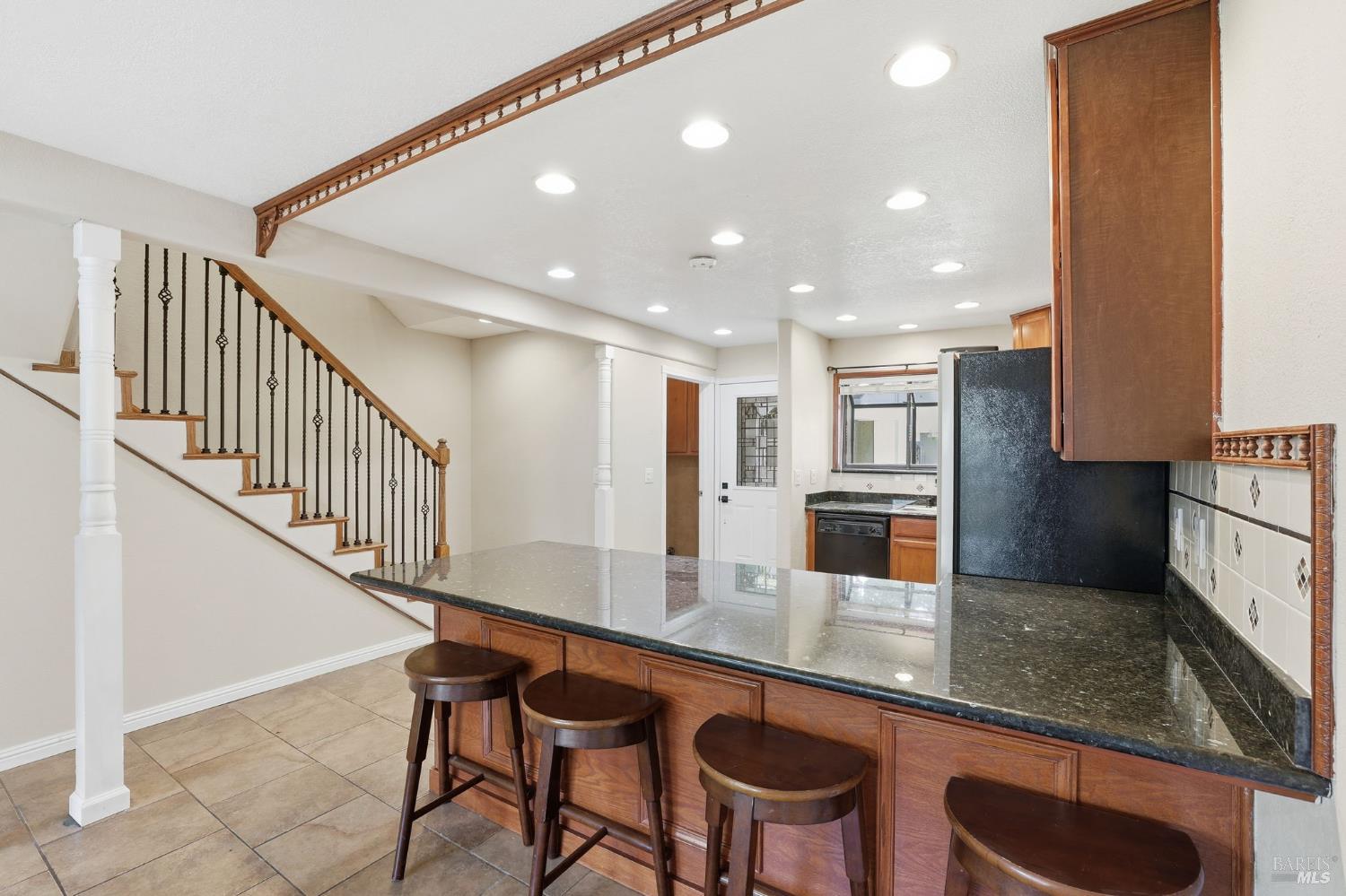 900 Southampton Road, Unit 169 Benicia, CA 94510 - Photo 12 of 21 a kitchen with stainless steel appliances granite countertop a table chairs sink and cabinets