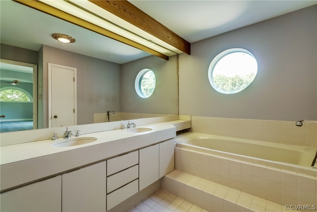 9910 Cherokee Road Richmond, VA 23235 - Photo 36 of 49 a bathroom with a double vanity sink and a mirror