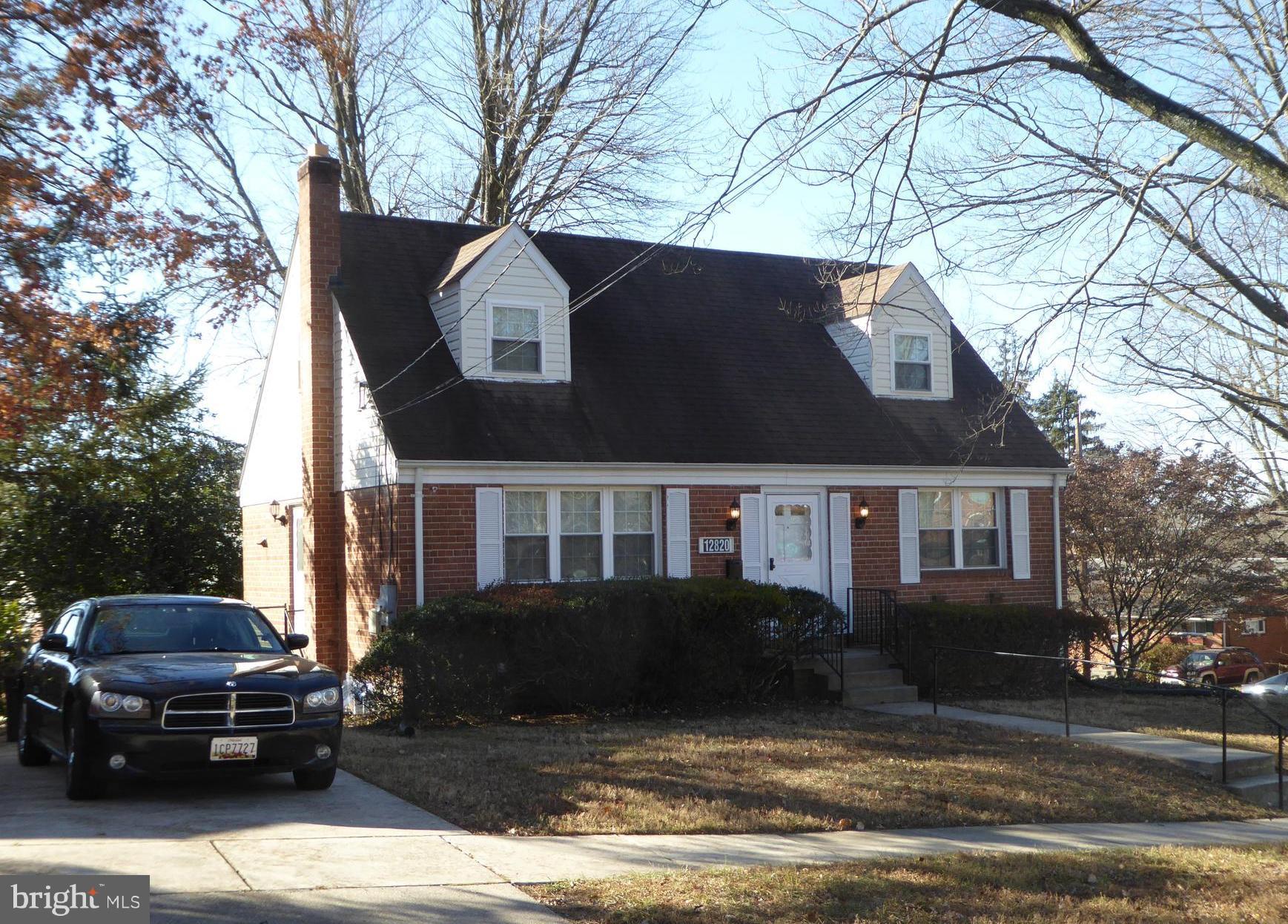 12820 Crisfield Road Silver Spring, MD 20906 - Photo 1 of 24 a house that has a tree in front of it