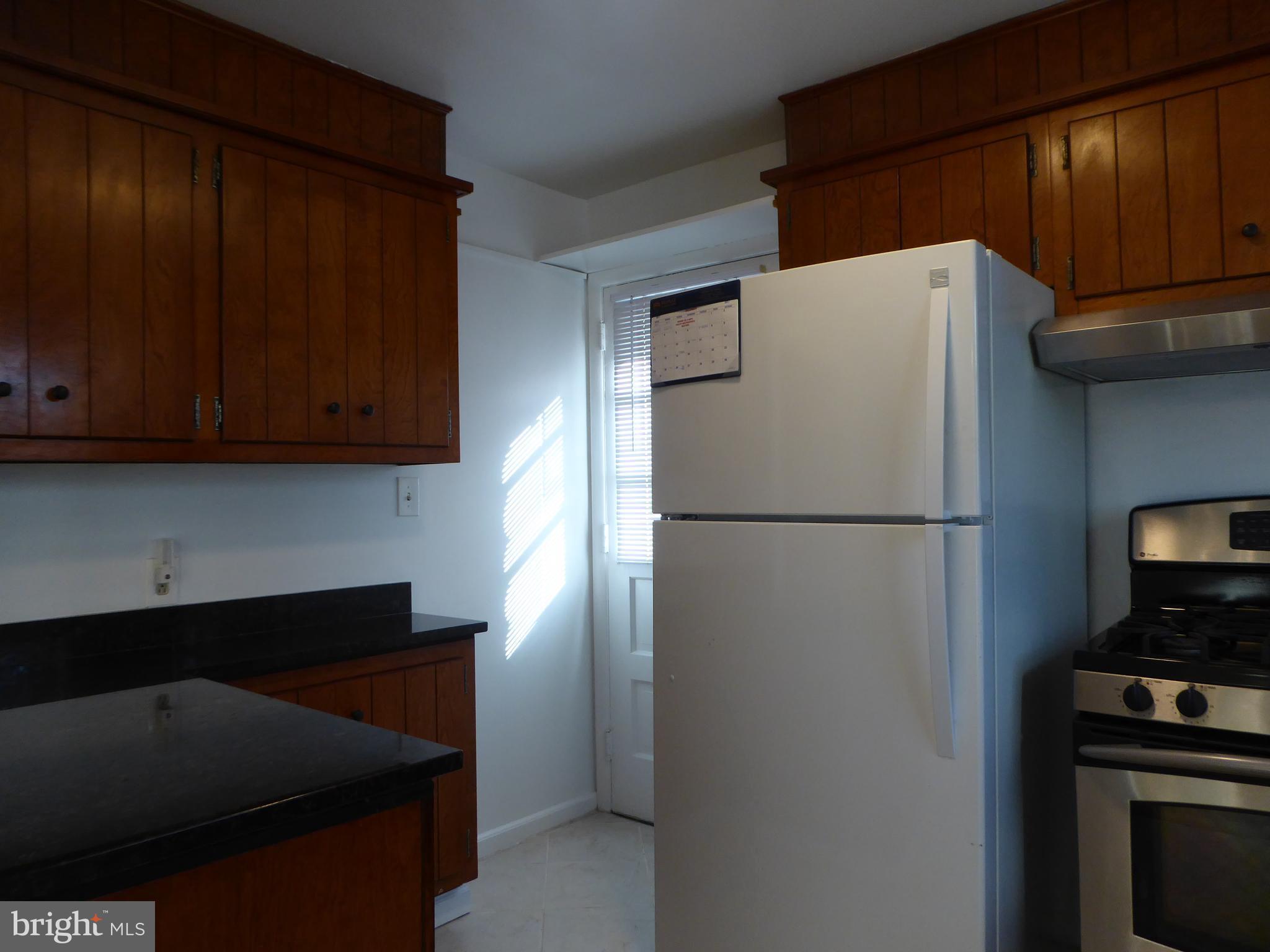 12820 Crisfield Road Silver Spring, MD 20906 - Photo 12 of 24 a white refrigerator freezer and a stove sitting inside of a kitchen