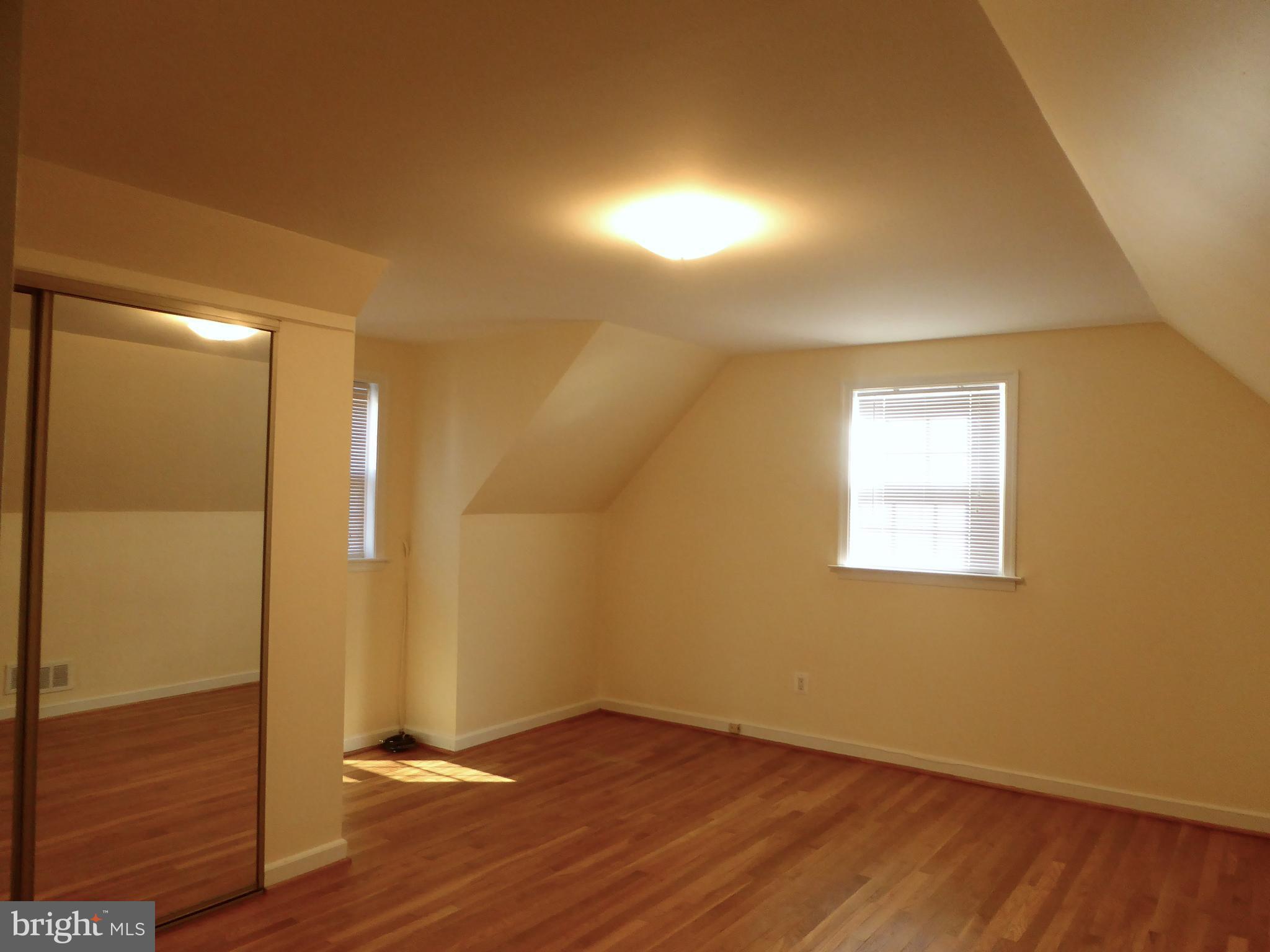 12820 Crisfield Road Silver Spring, MD 20906 - Photo 17 of 24 an empty room with wooden floor and windows