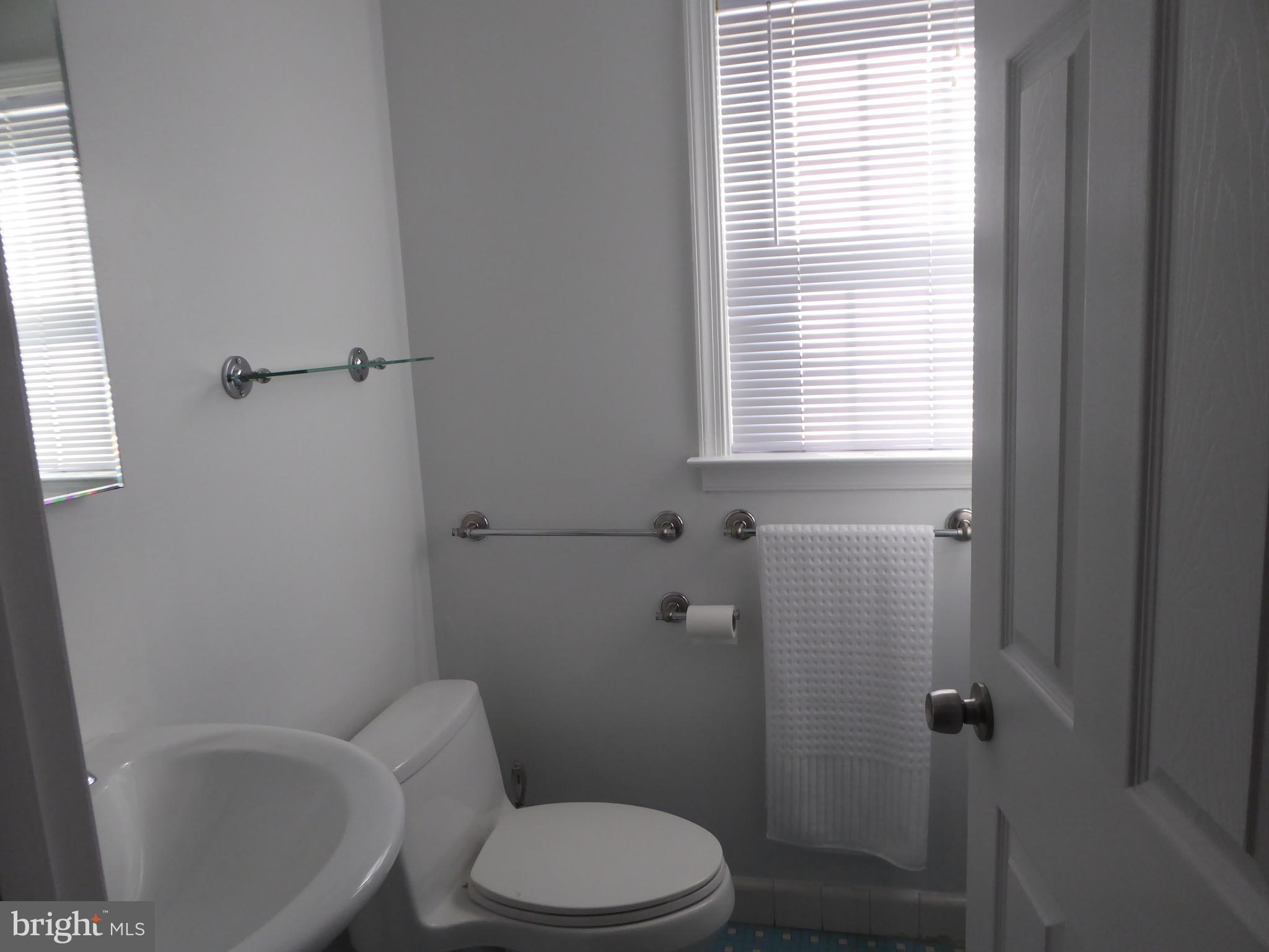12820 Crisfield Road Silver Spring, MD 20906 - Photo 18 of 24 a white toilet sitting next to a bath tub
