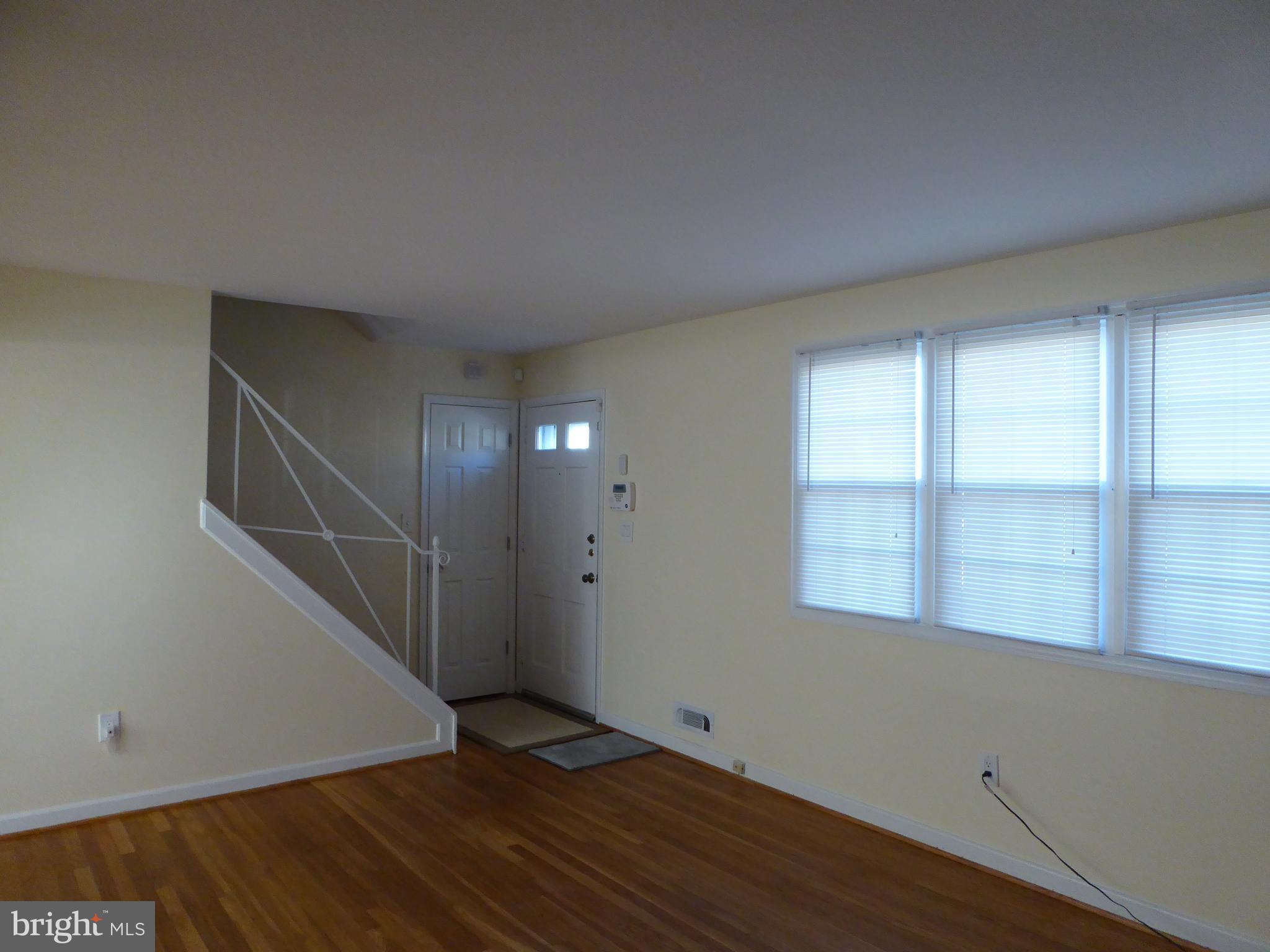 12820 Crisfield Road Silver Spring, MD 20906 - Photo 6 of 24 an empty room with wooden floor and windows