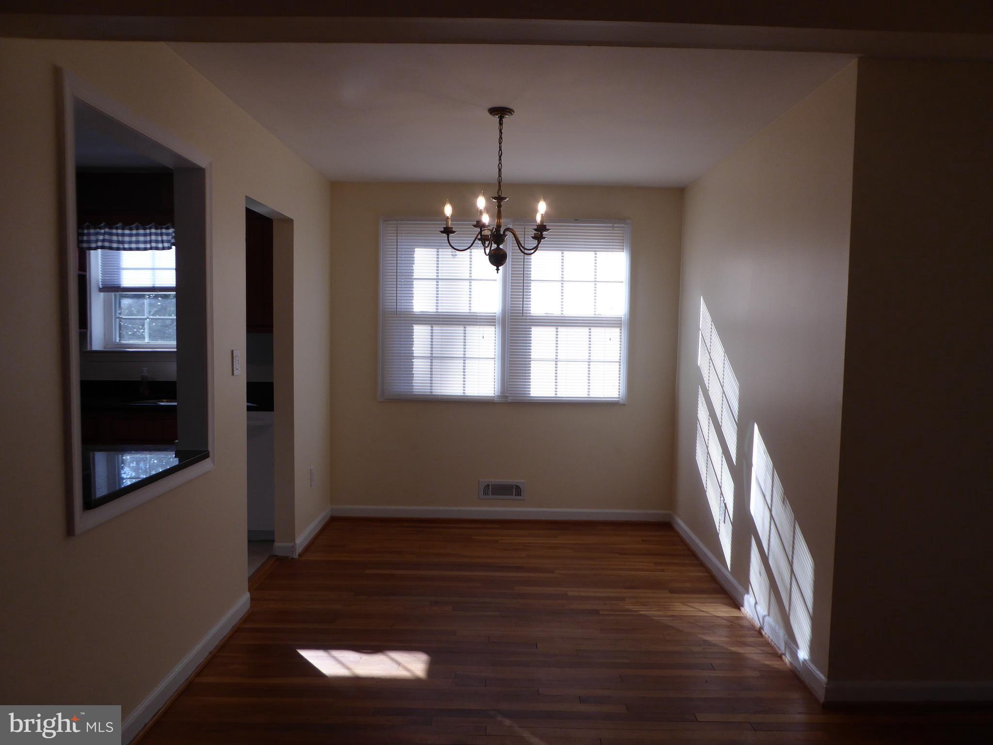 12820 Crisfield Road Silver Spring, MD 20906 - Photo 9 of 24 a view of empty room with wooden floor and fan