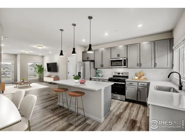 a kitchen with counter top space a sink appliances and cabinets
